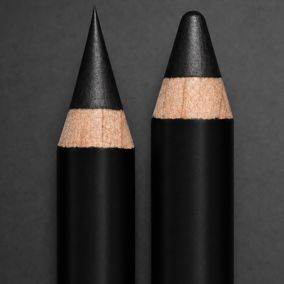 Two cosmetic pencils, one sharpened to a fine point and one to a rounded point
