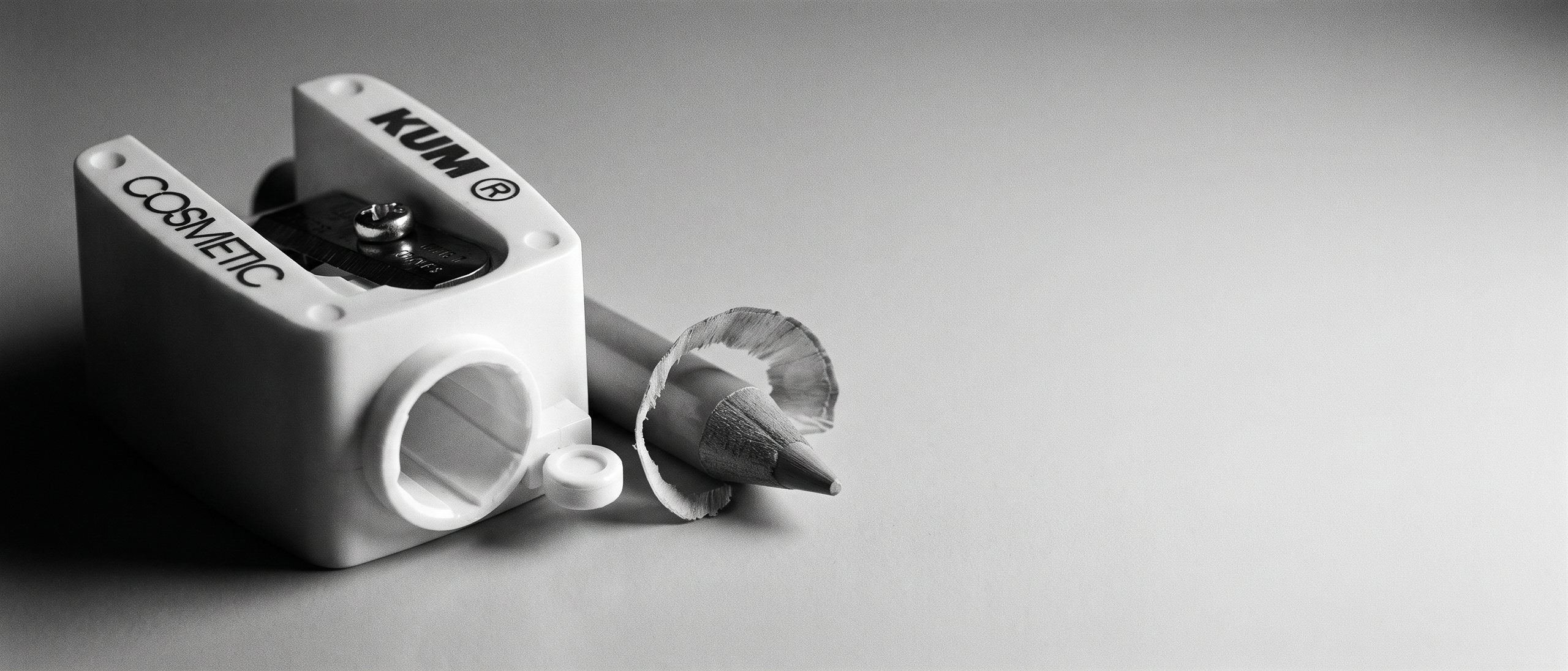 KUM Revolution sharpener with a freshly sharpened pencil, showing the grooved cone